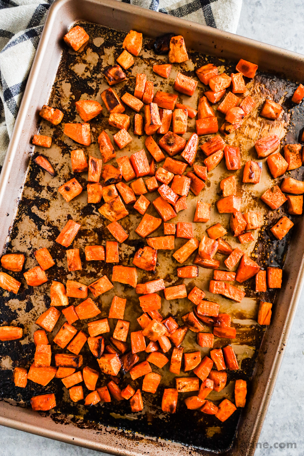 Close up of roasted sweet potatoes on a baking sheet.