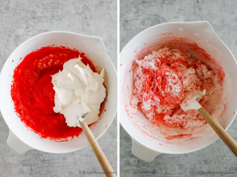 Whipped cream and strawberry jello mixture being stirred together in a bowl.