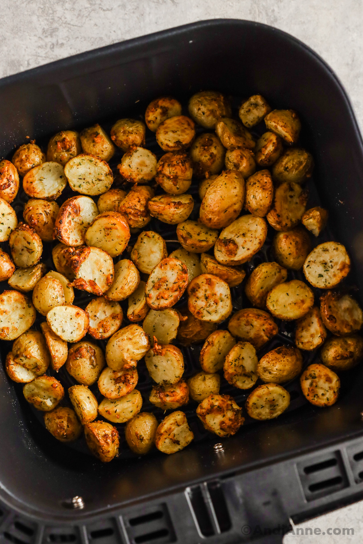 Air fryer with crispy baby potatoes.