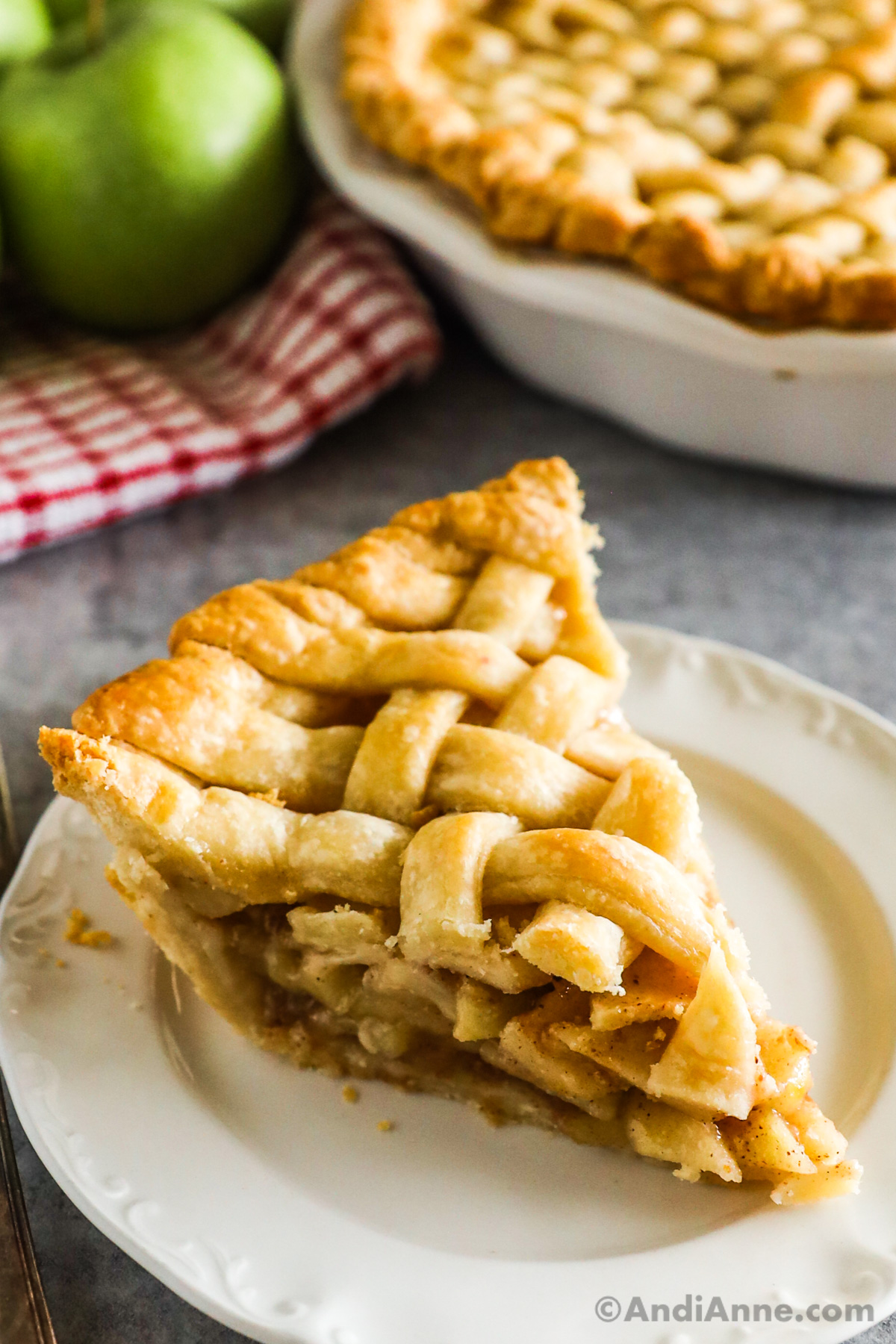 A slice of apple pie with lattice crust.