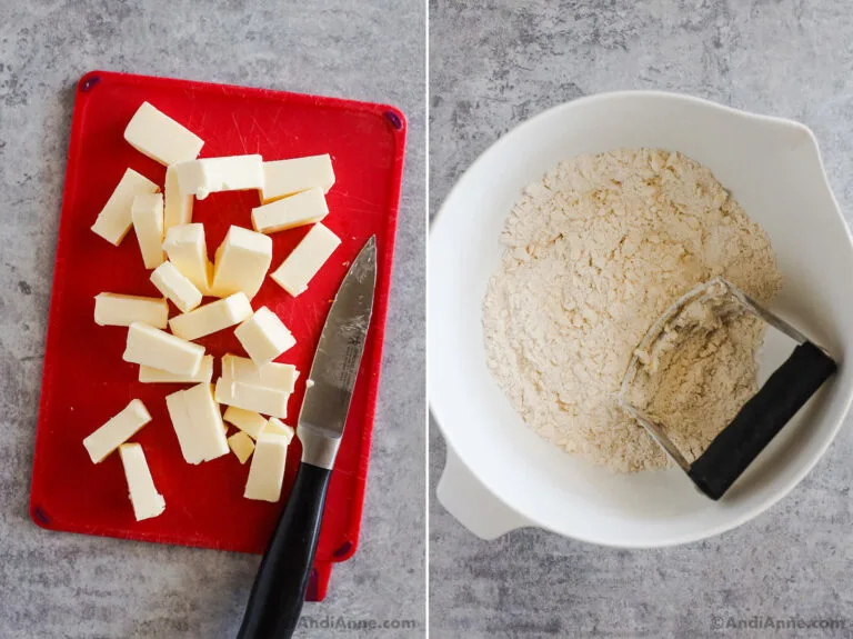 A cutting board with butter cubes. A bowl with dry ingredients and a pastry cutter.