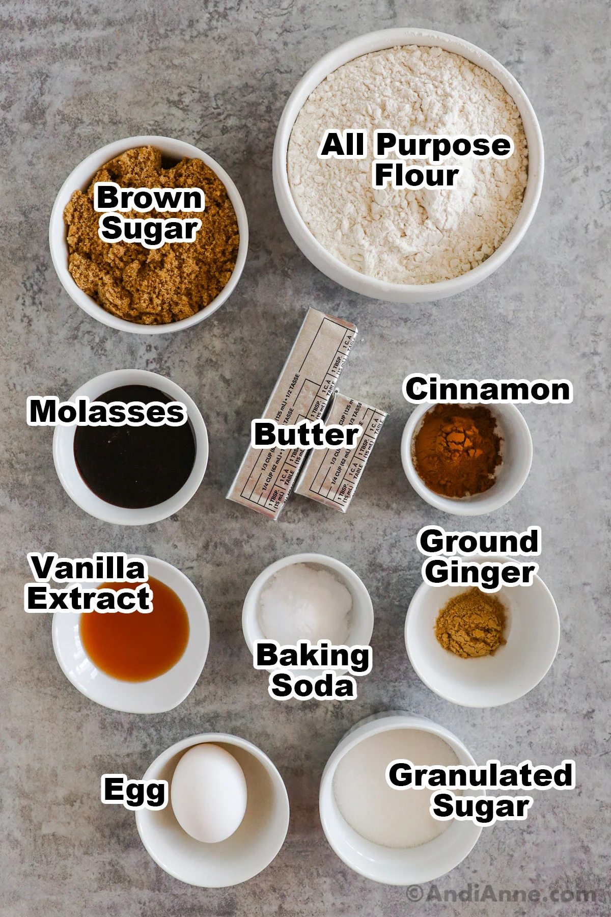 Recipe ingredients in bowls including brown sugar, flour, molasses, cinnamon, vanilla, ginger, baking soda and eggs.