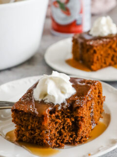 Slices of gingerbread cake topped with caramel sauce and whipped cream.