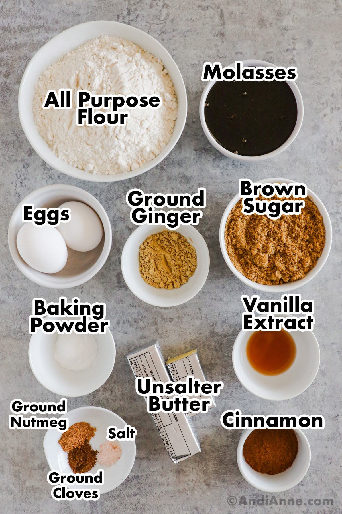 Bowls of recipe ingredients including flour, molasses, brown sugar, ground ginger, eggs, baking powder, vanilla extract, spices and butter.