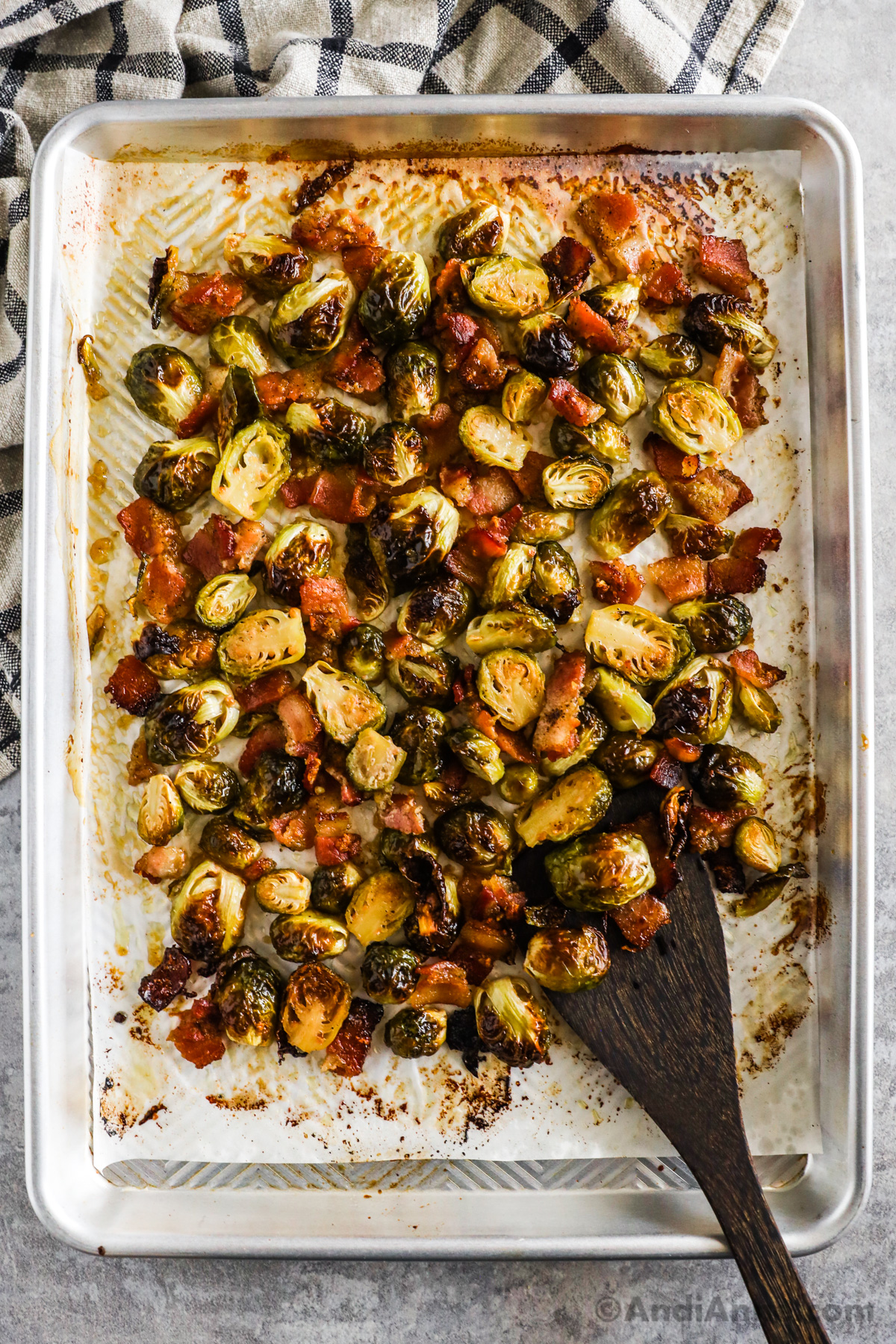 A baking sheet with roasted maple bacon brussels sprouts.