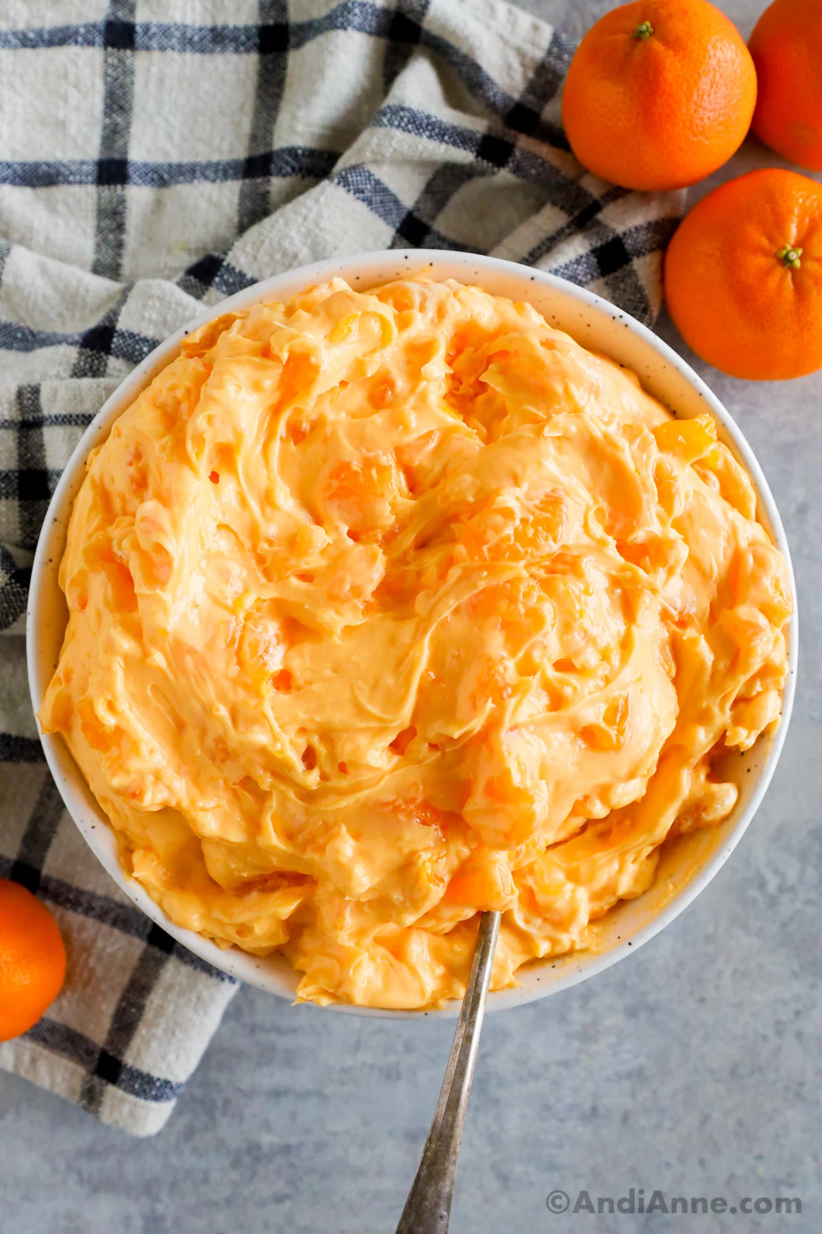 A bowl of orange jello fluff salad.