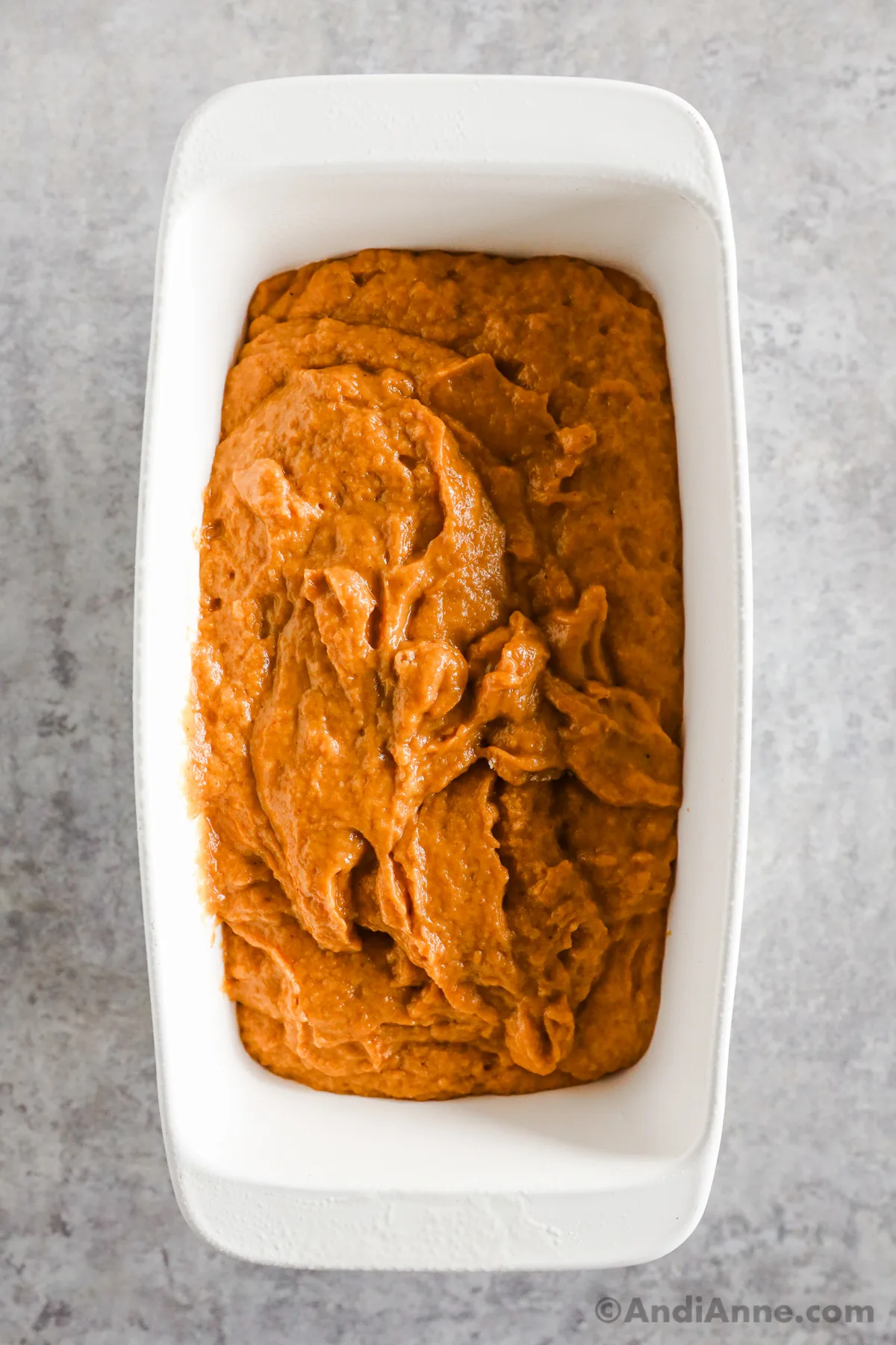 Batter in a white loaf pan.