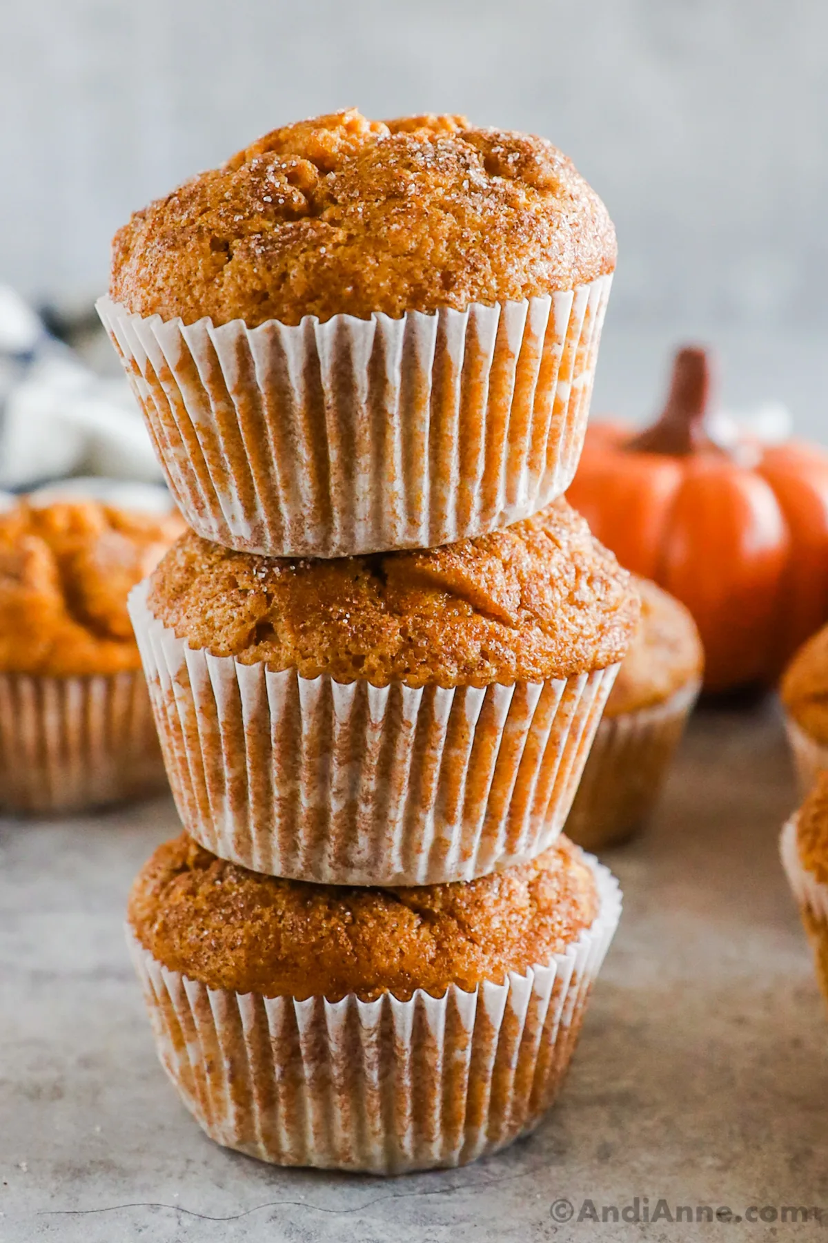 Three pumpkin muffins stacked on top of eachother.