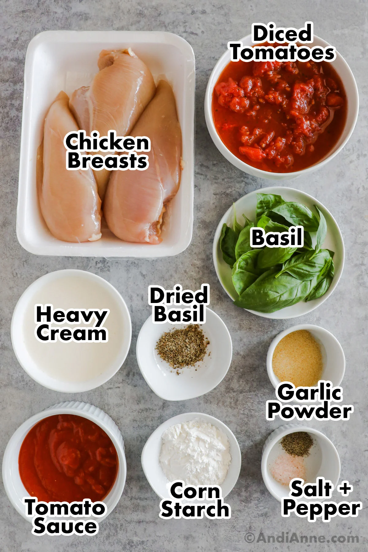 Overhead view of each ingredient in a separate bowl. Chicken breasts, tomatoes, fresh basil, dried basil, heavy cream, garlic powder, tomato sauce, corn starch, salt and pepper