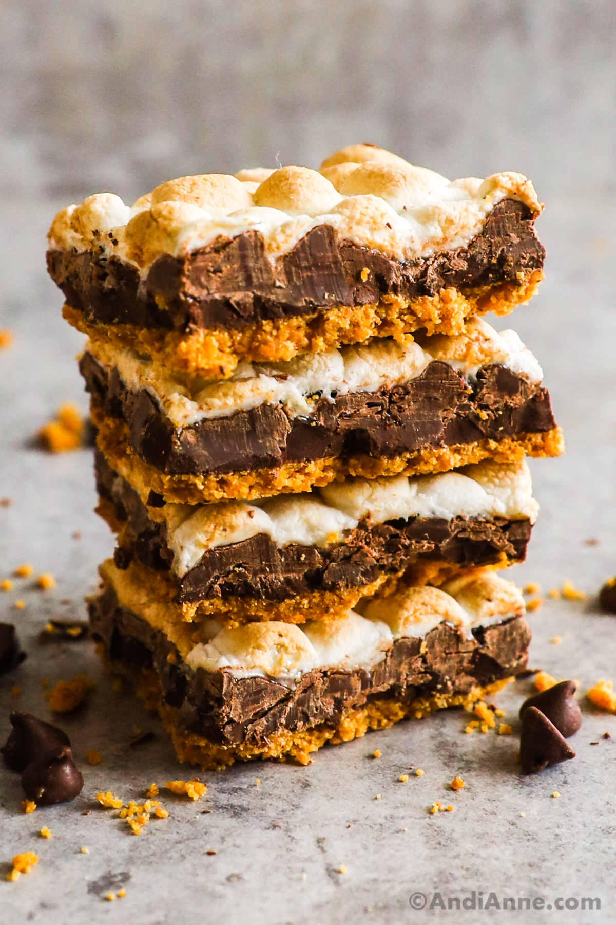 Stack of four squarely cut slices of finished s'more bars.