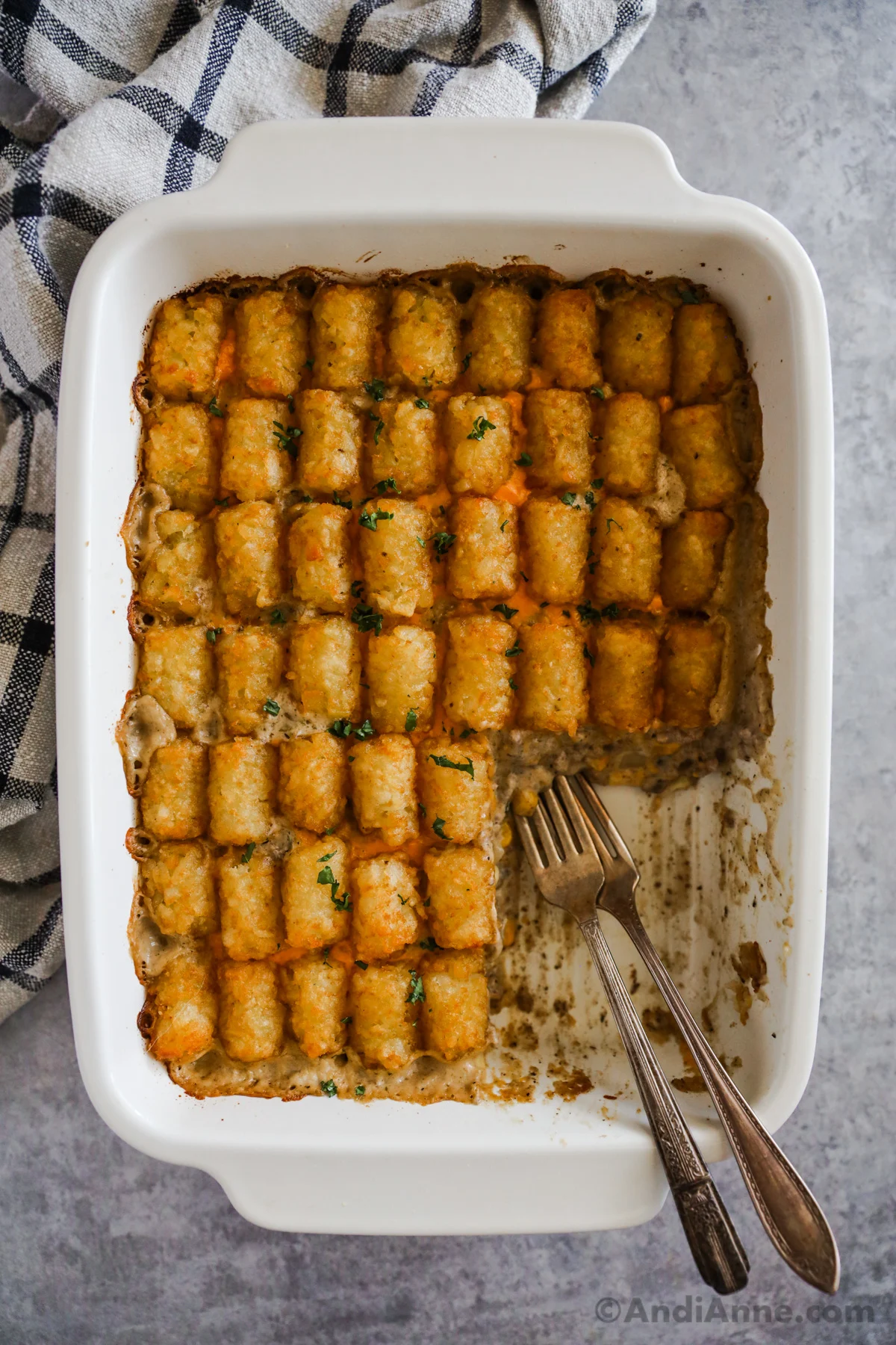 Overhead view of the finished casserole with one serving removed and forks in it's place