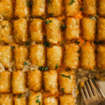 Close up of tater tot casserole with two forks.