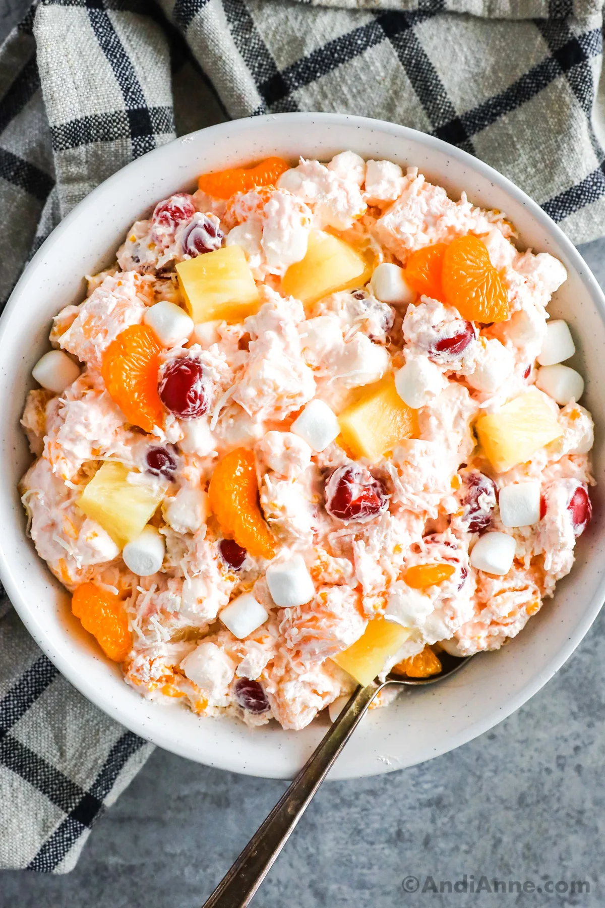 Bowl of ambrosia salad with a spoon.