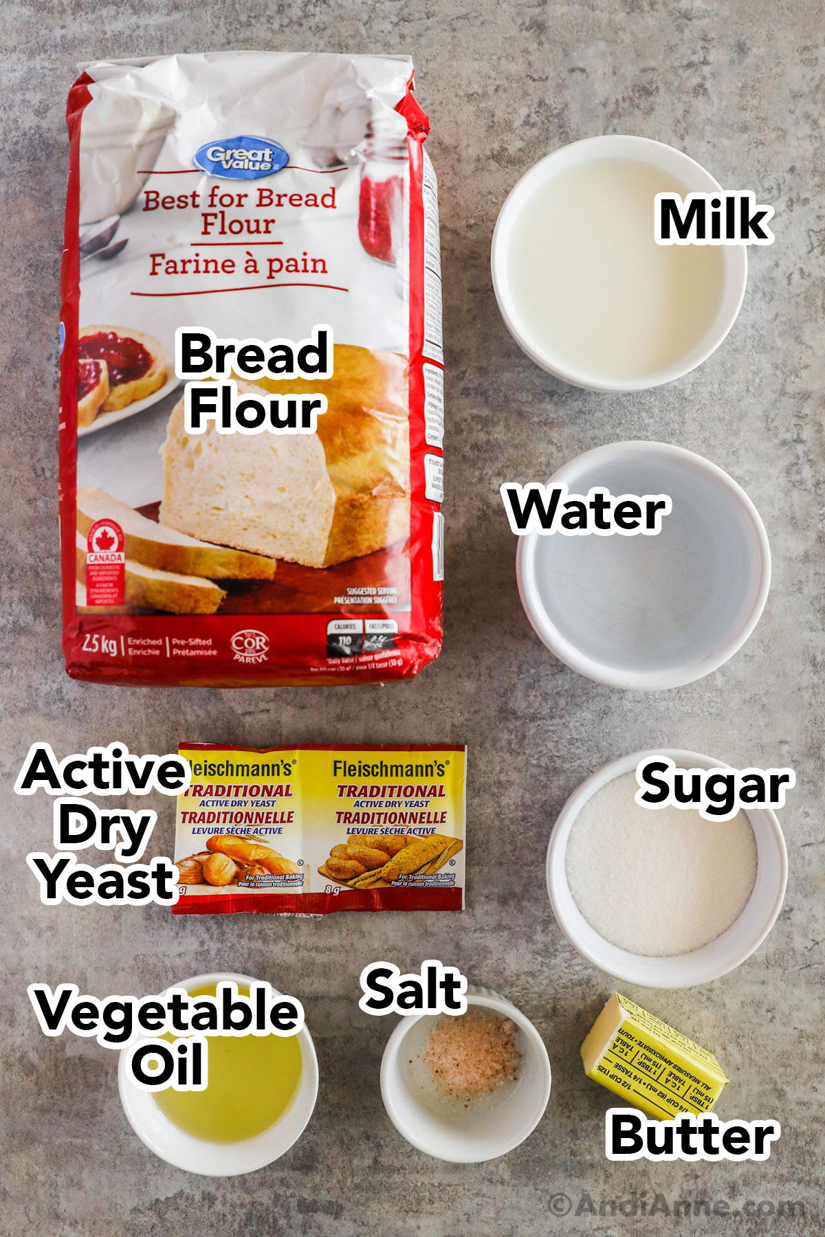 Bag of bread flour, bowls of milk, water, sugar, vegetable oil, salt, butter and packets of dry yeast.