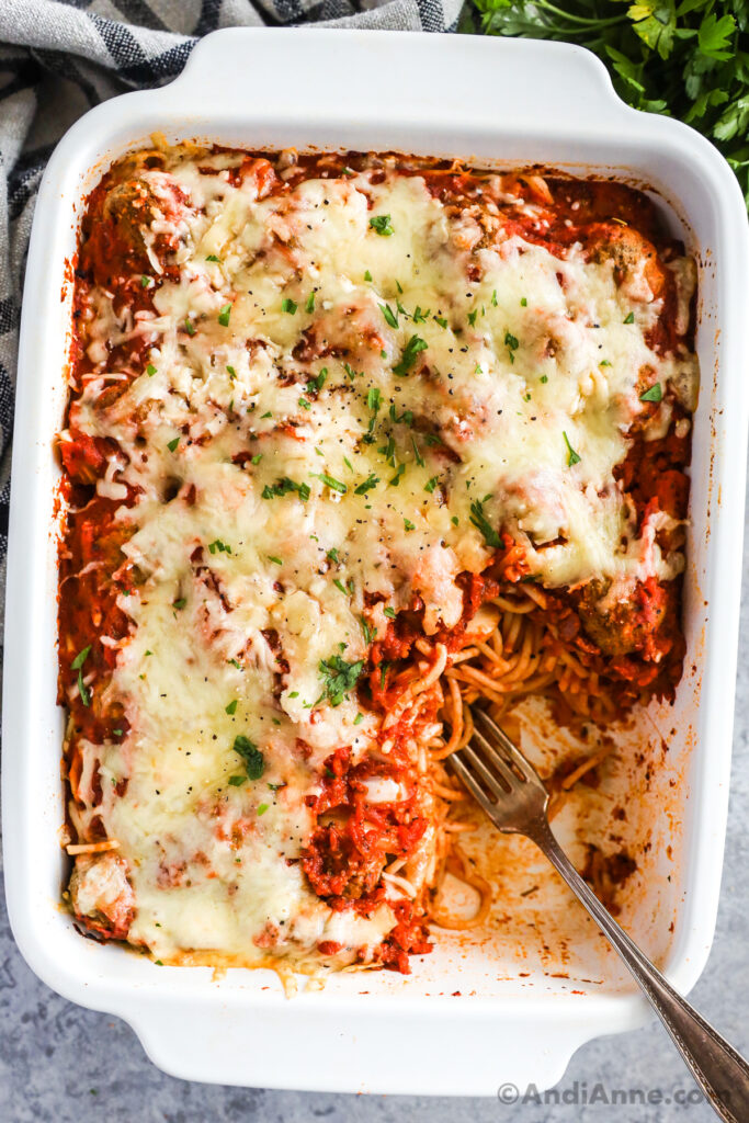 Casserole dish with baked spaghetti and meatballs.