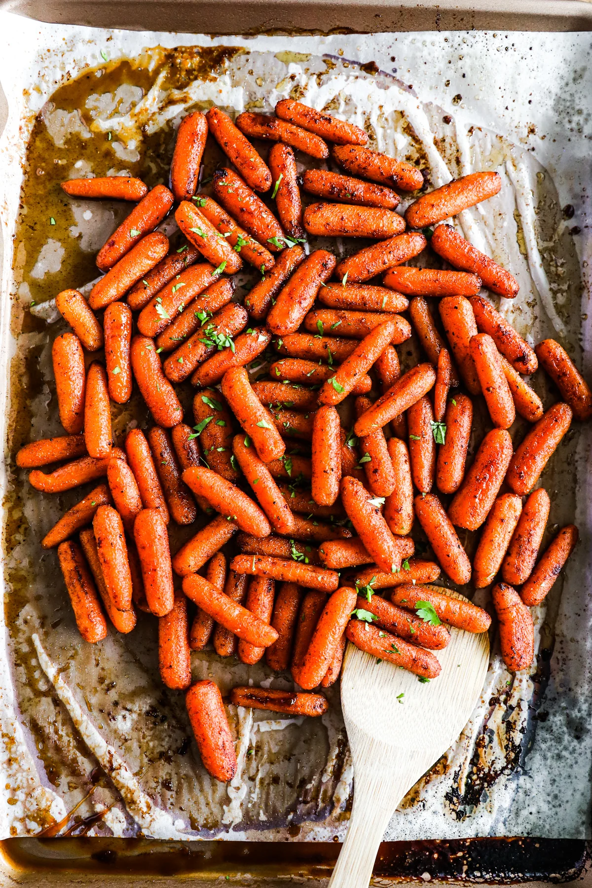 Close up of brown sugar baked carrots on baking sheet.