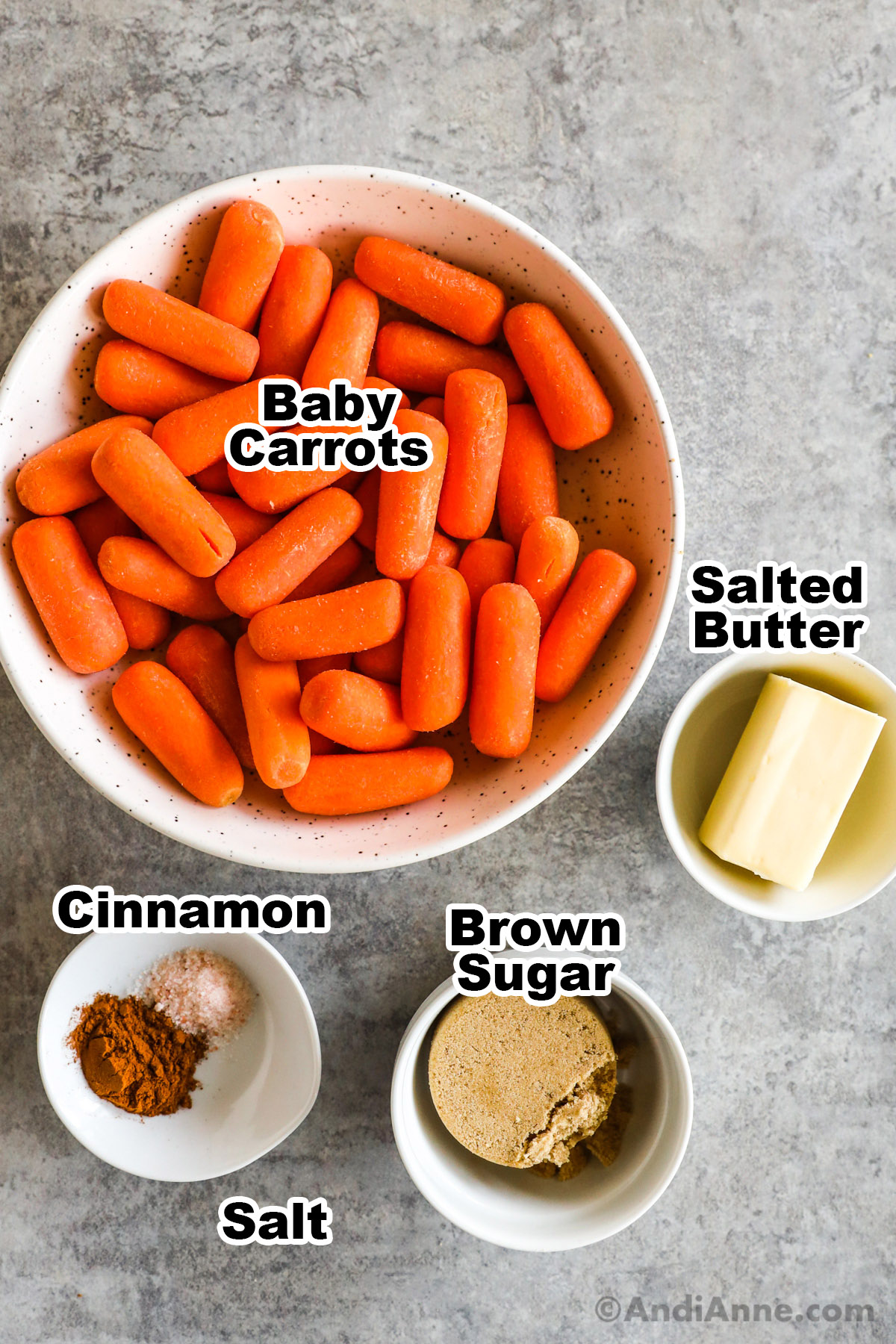 Bowls of recipe ingredients including baby carrots, butter, brown sugar, cinnamon and salt