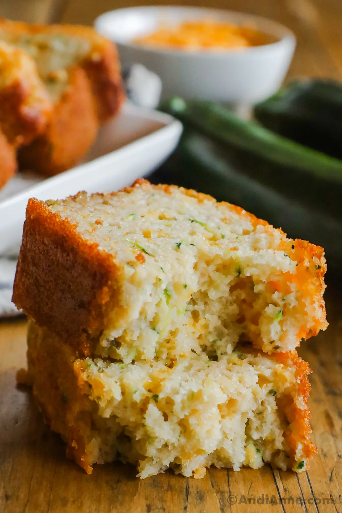 Close up of a piece of cheddar zucchini beer bread broken in half.