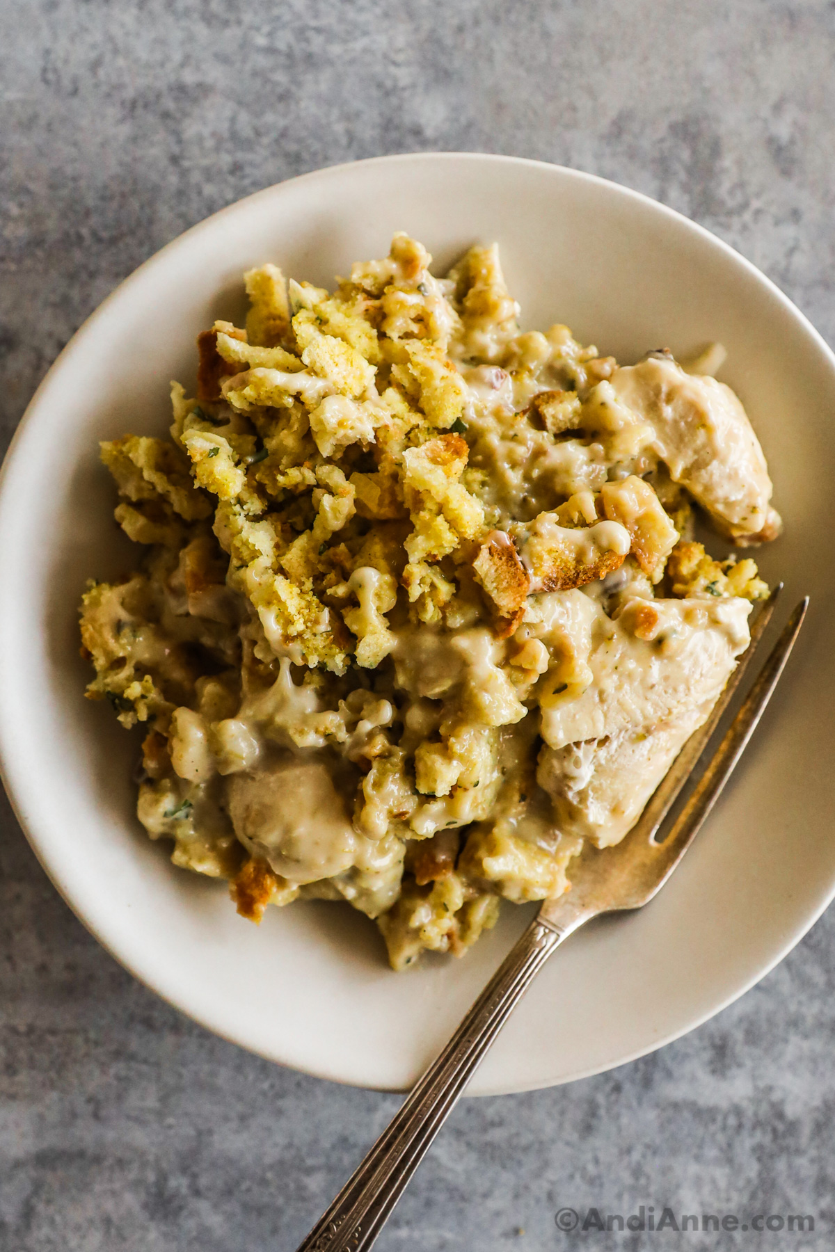 A plate of chicken stuffing casserole recipe with a fork.