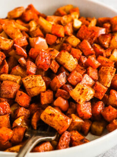 A plate of cinnamon roasted sweet potatoes and apples.