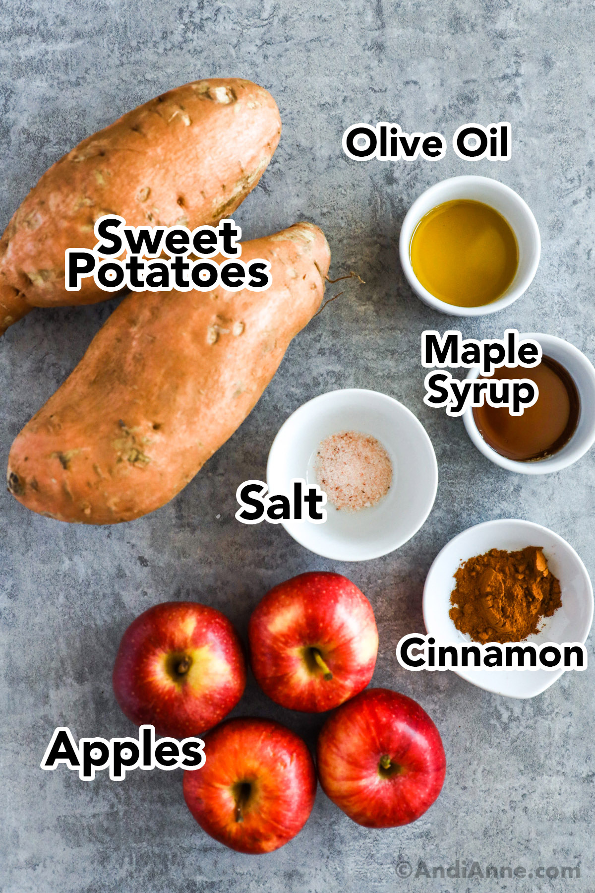 Recipe ingredients including sweet potatoes, apples, bowls of cinnamon, salt, maple syrup, and olive oil.