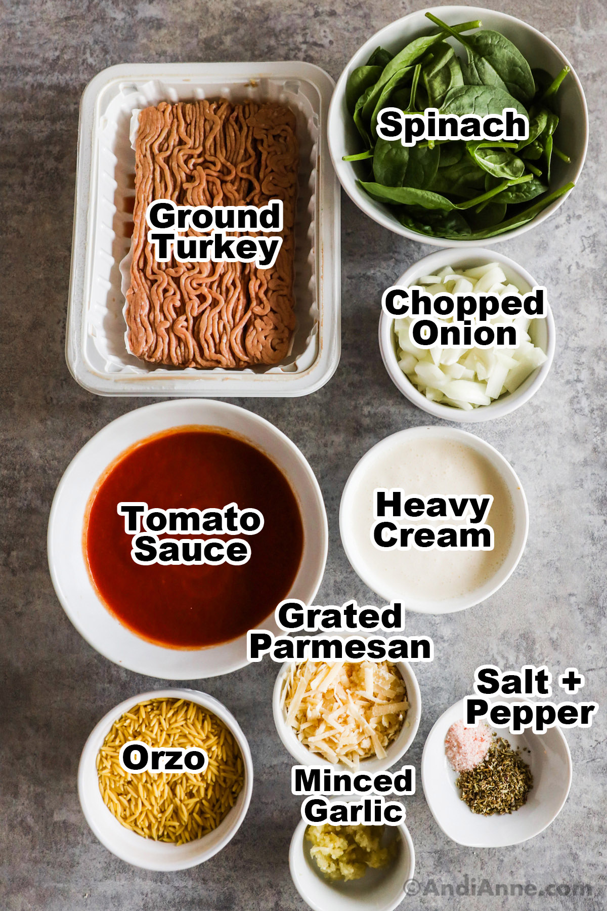 Recipe ingredients in bowls including ground turkey, spinach, chopped onion, tomato sauce, heavy cream, grated parmesan, orzo, minced garlic, salt and pepper.