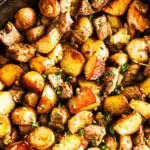 Garlic butter steak bites and potatoes in a skillet