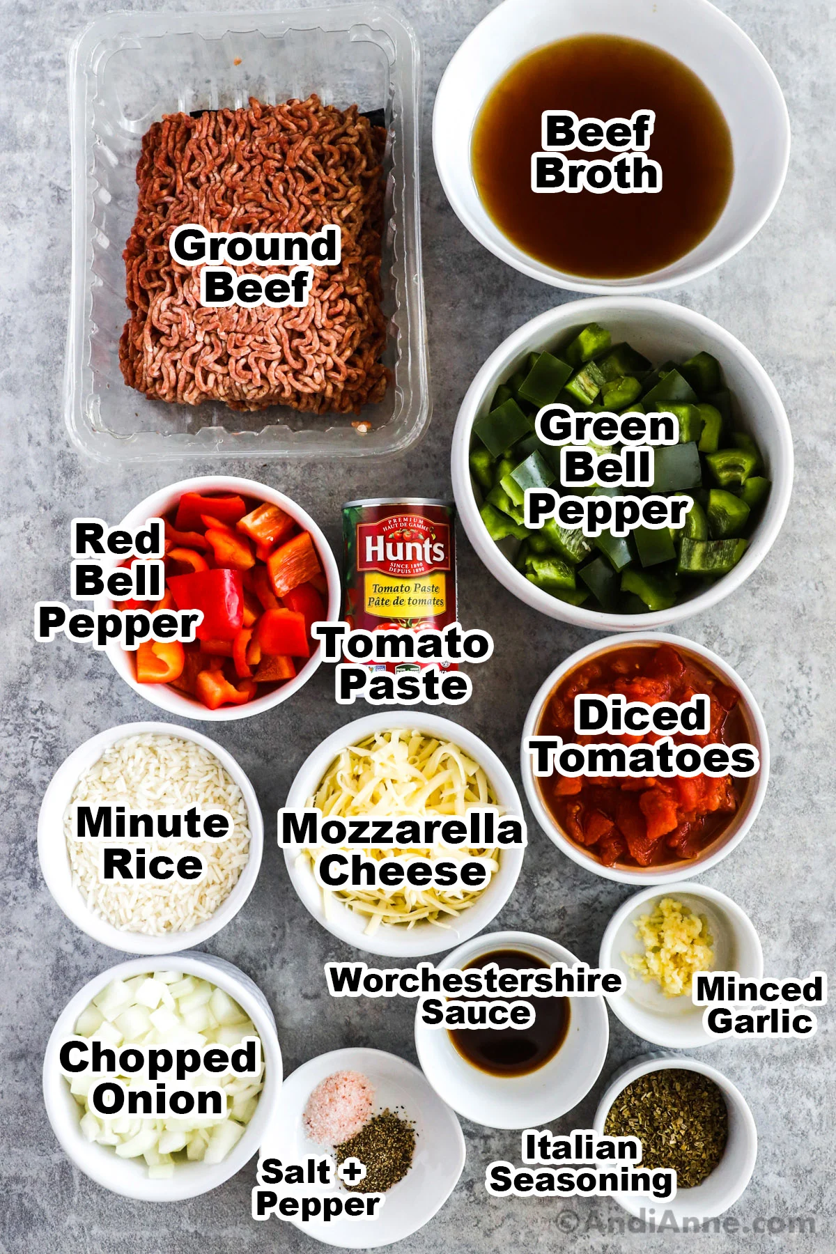 Recipe ingredients including raw ground beef, bowl of beef broth, bell peppers, diced tomatoes, cheese, seasonings, and onion.