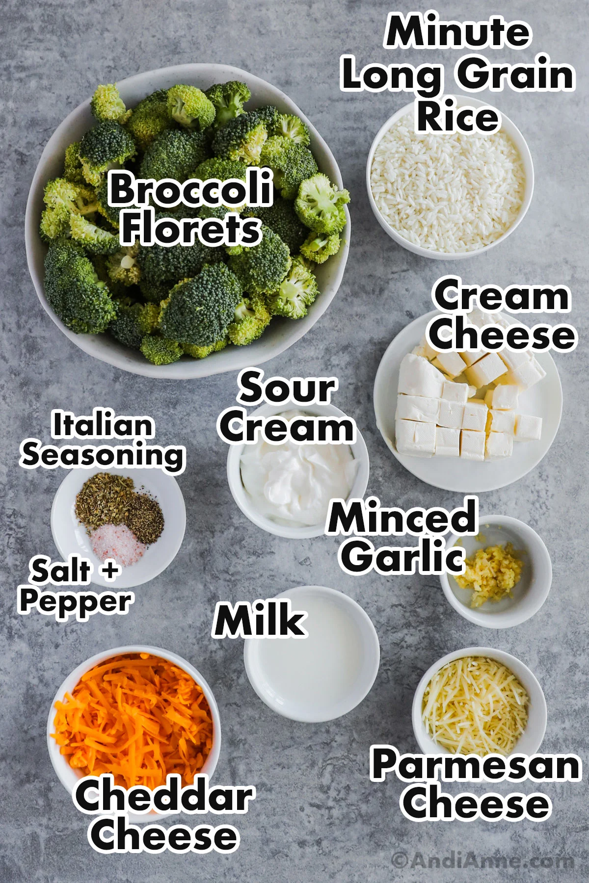 Recipe ingredients on the counter including a bowl of broccoli floret, bowls of minute rice, cubed cream cheese, sour cream, minced garlic, milk, shredded cheddar cheese, parmesan cheese and spices.
