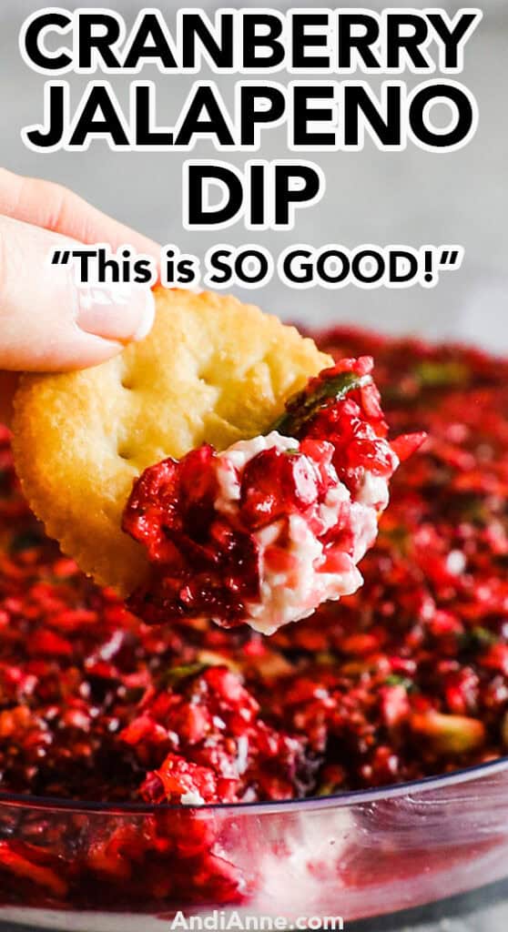 cracker with a scoop of cranberry jalapeno dip on it and the rest of the bowl in the background