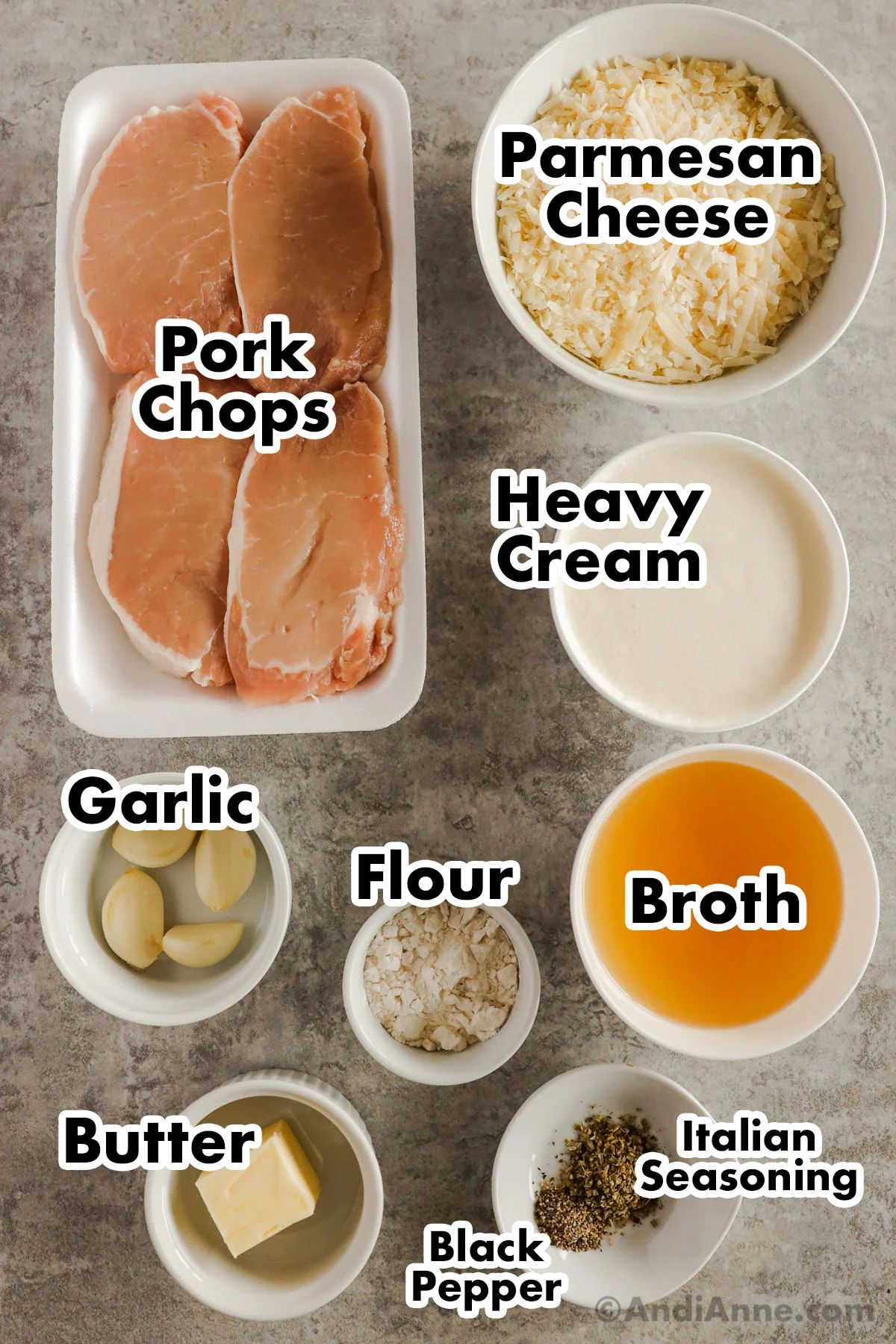 Recipe ingredients in containers including pork chops, grated parmesan, cream, garlic, flour, broth, butter, and spices.