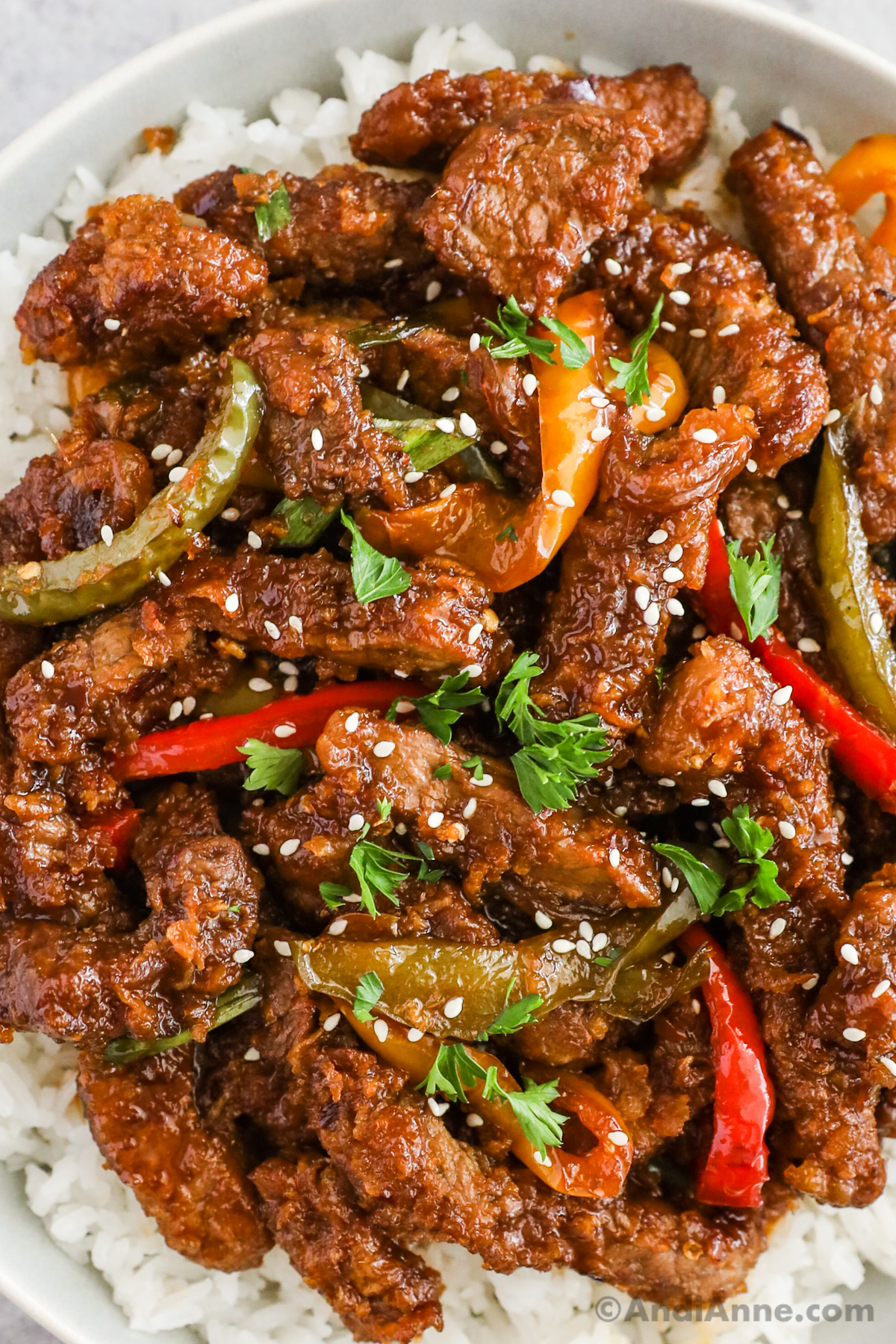 Close up of mongolian beef with bell pepper and sesame seeds.