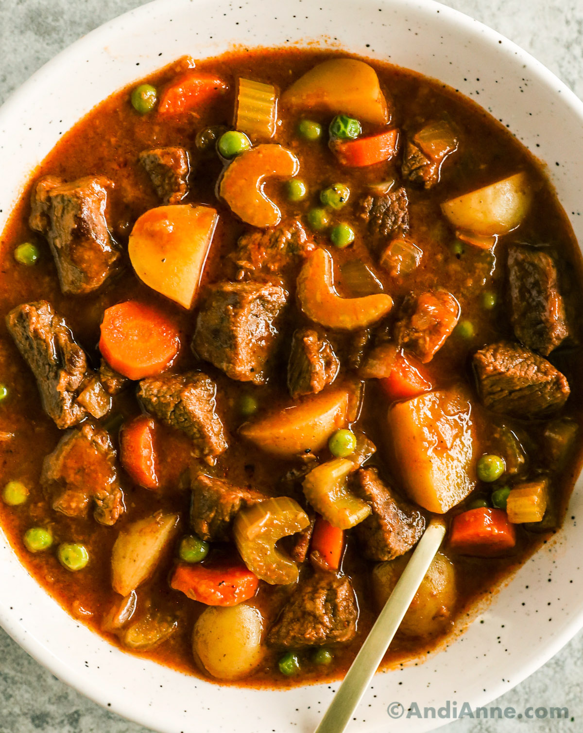 Overhead view of finished Beef stew in a bowl with a spoon.