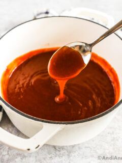 A pot of sweet and sour sauce with a spoon.