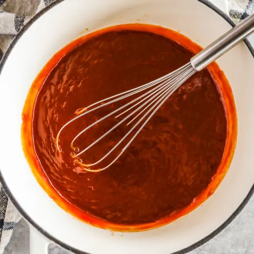 pot of sweet and sour sauce with a whisk
