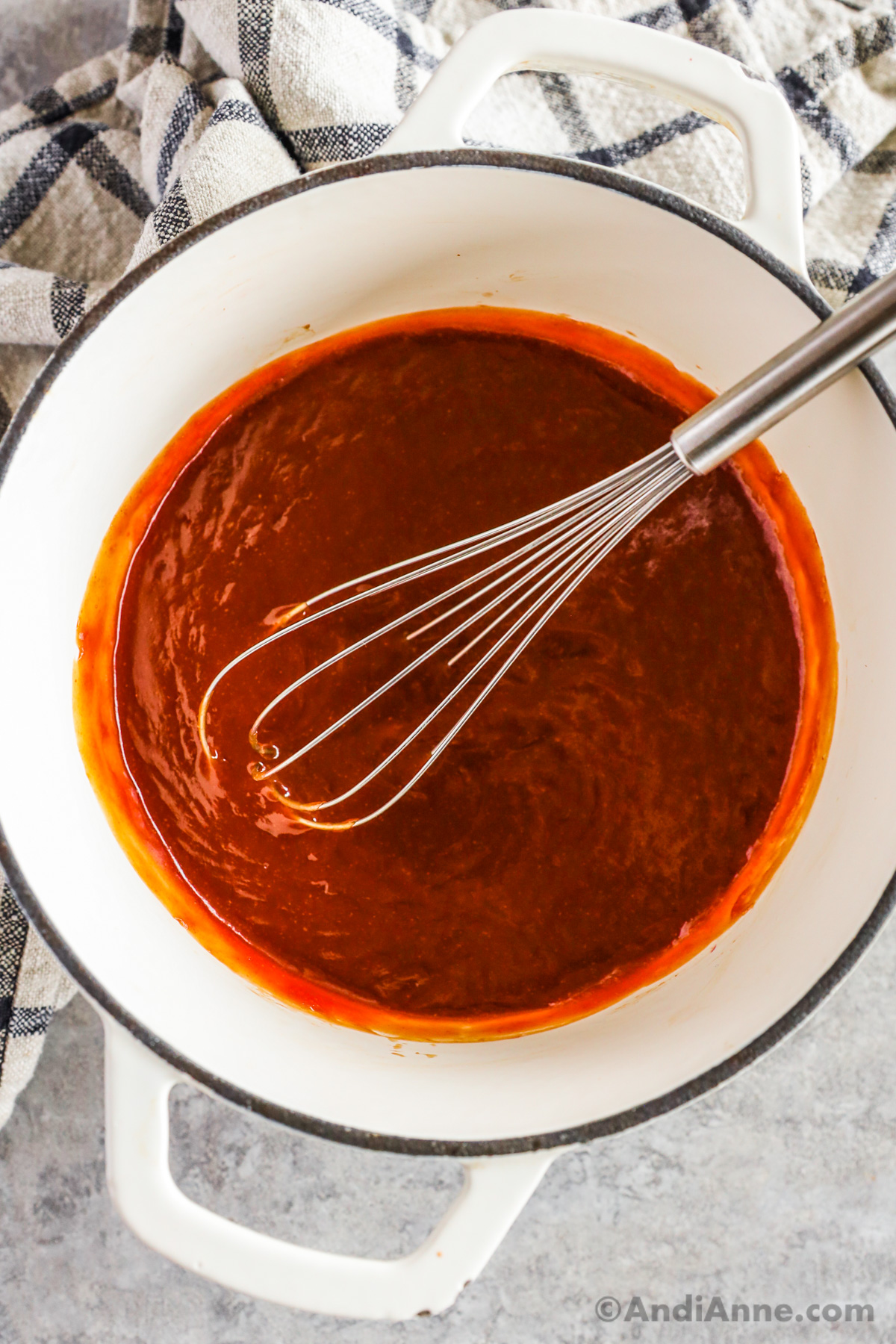 pot of sweet and sour sauce with a whisk