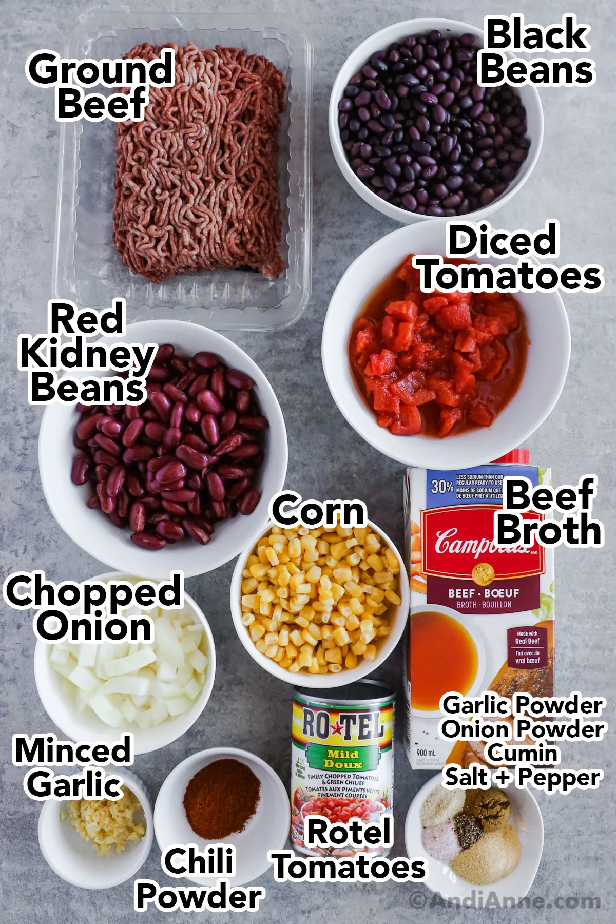 Recipe ingredients in containers including raw ground beef, bowls of black beans, kidney beans, diced tomatoes, corn, broth, onion and spices.