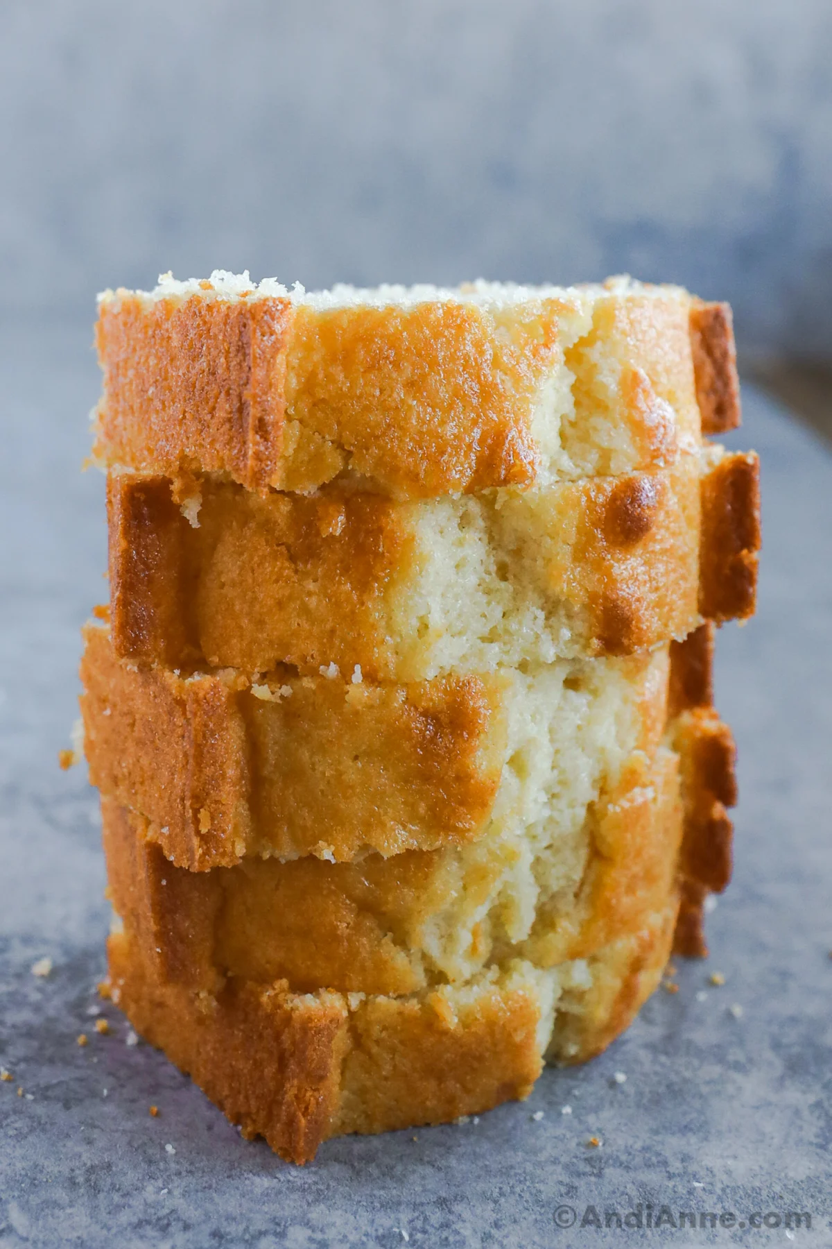 A stack of slices of vanilla pound cake, stacked on top of eachother.