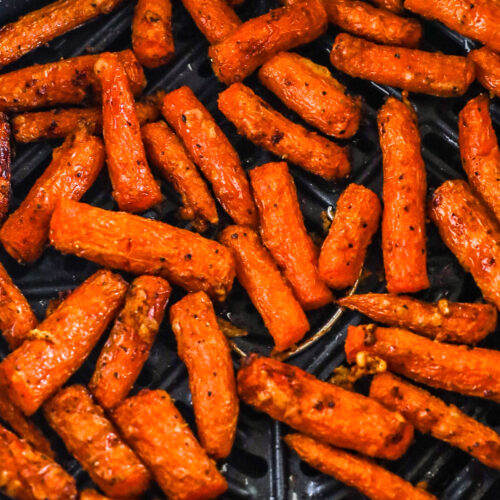 Air fryer basket with carrots inside