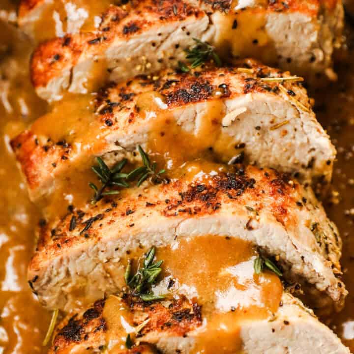 close up of sliced pork tenderloin with gravy