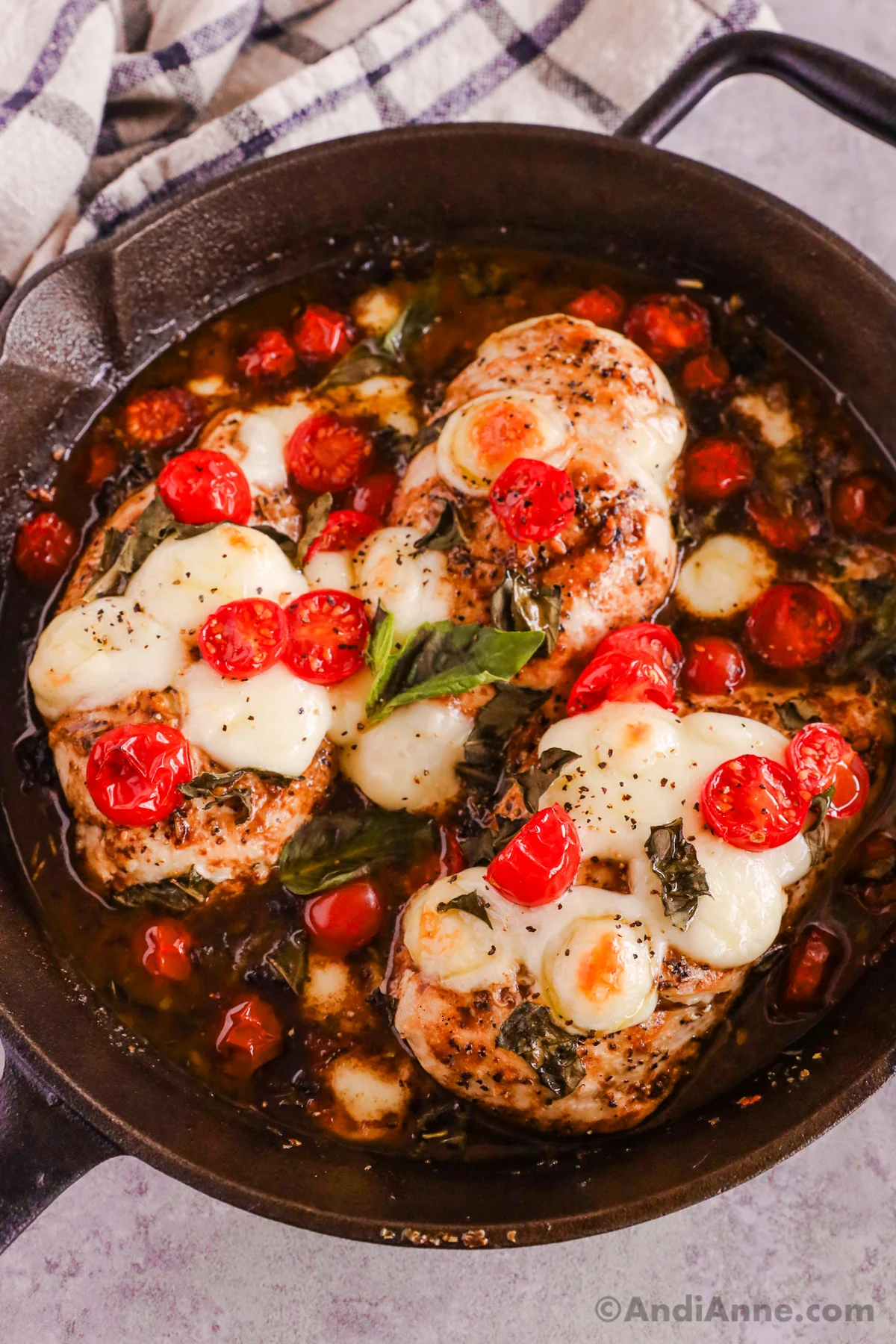 Cast iron skillet with basil balsamic chicken recipe inside.