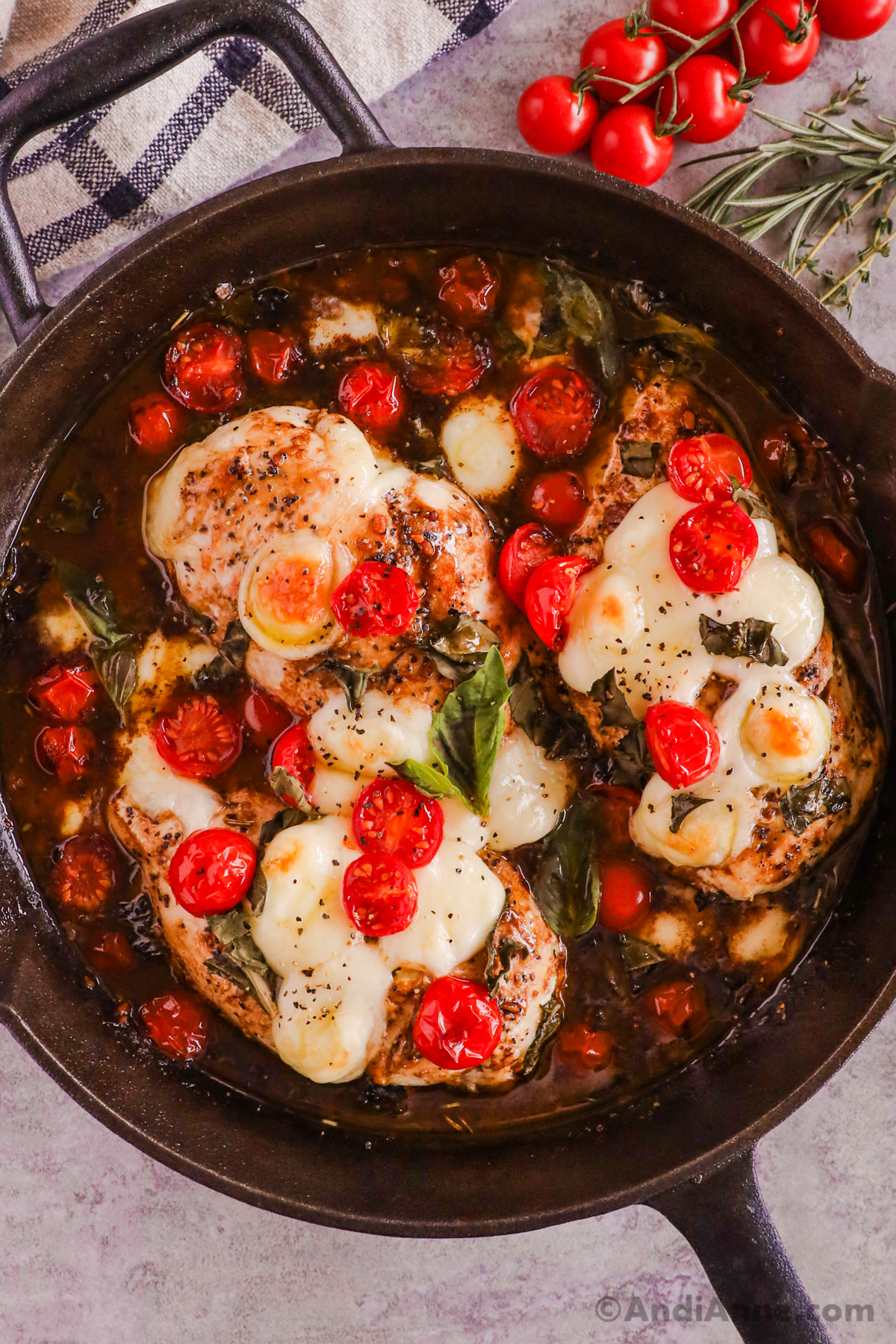 A skillet with basil balsamic tomato chicken recipe.
