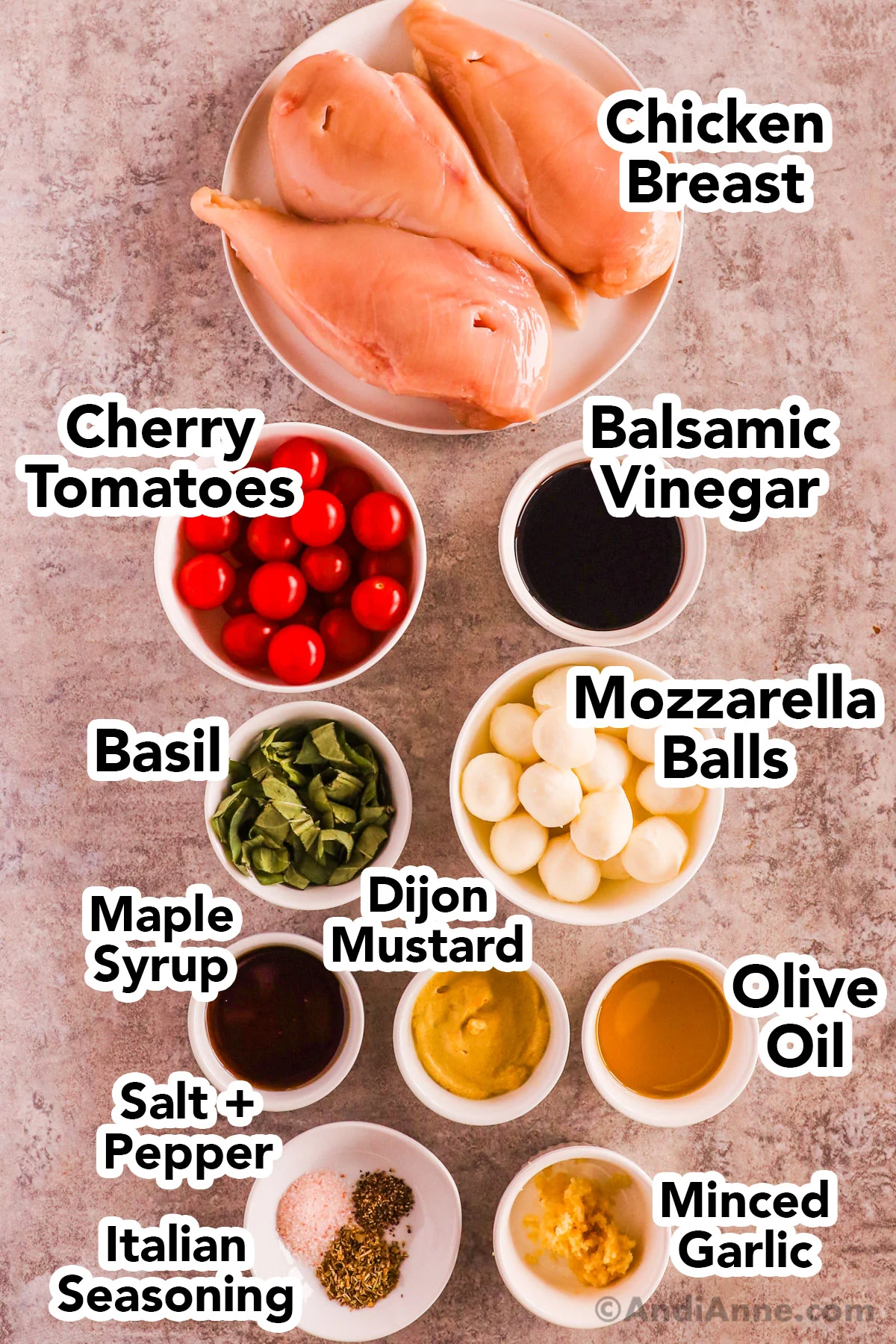 Recipe ingredients in bowls including cherry tomatoes, balsamic vinegar, mozzarella balls, basil, raw chicken breasts, maple syrup, dijon mustard, olive oil, salt and pepper and minced garlic.