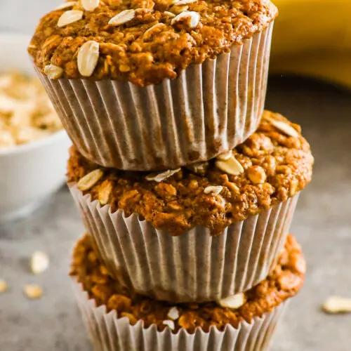 Stack of banana oatmeal muffins on top of eachother