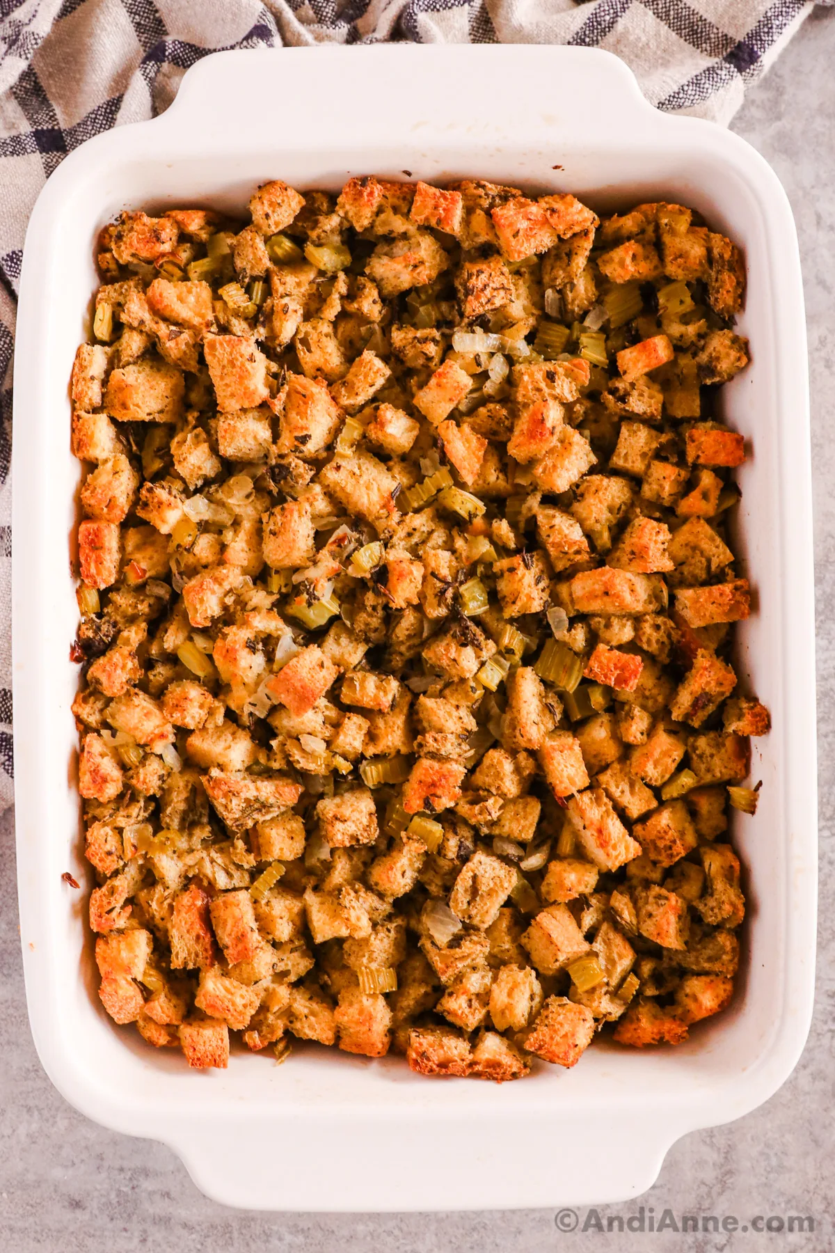 A white casserole dish with homemade stuffing inside.