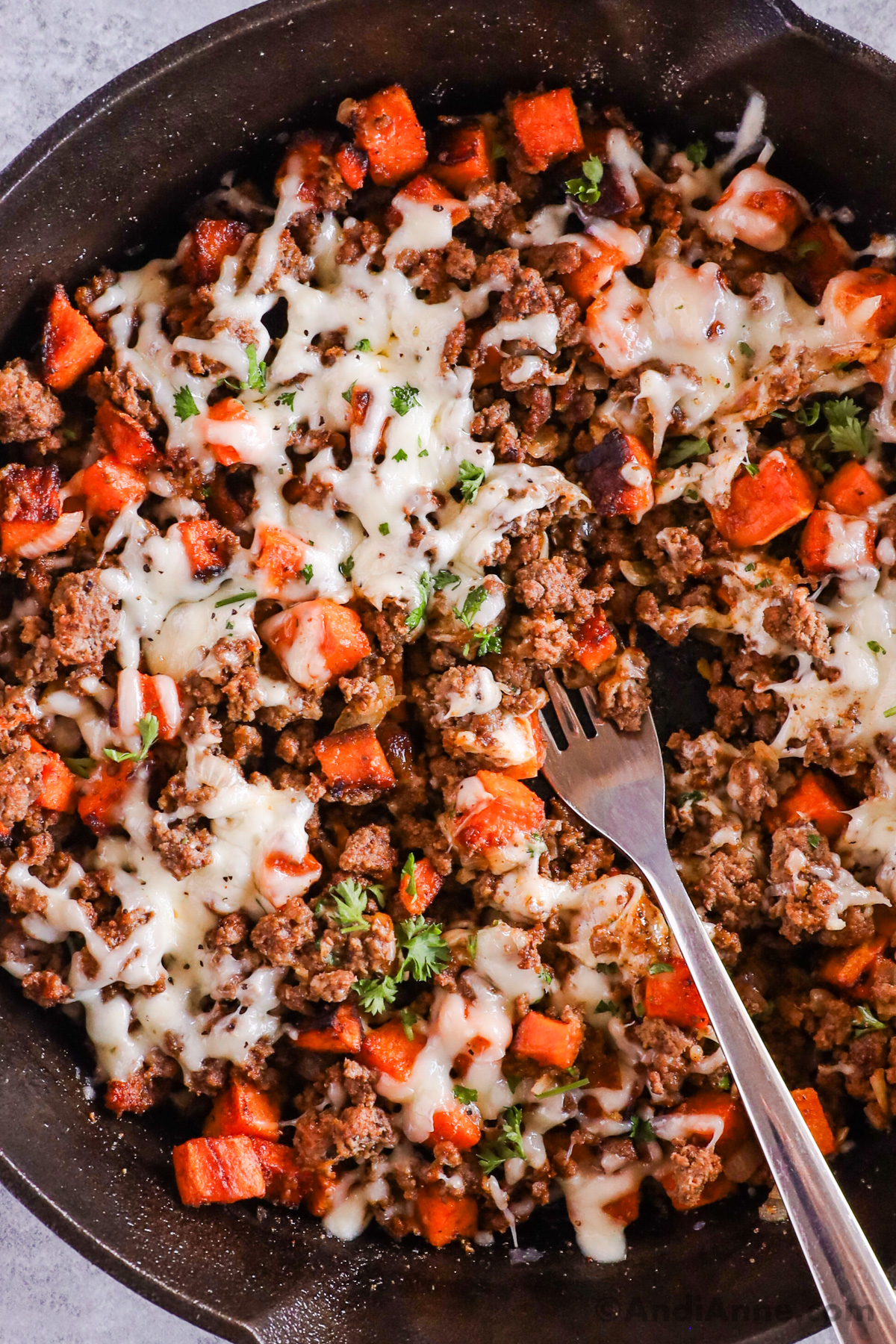 Close up of ground beef sweet potato skillet with melted cheese on top