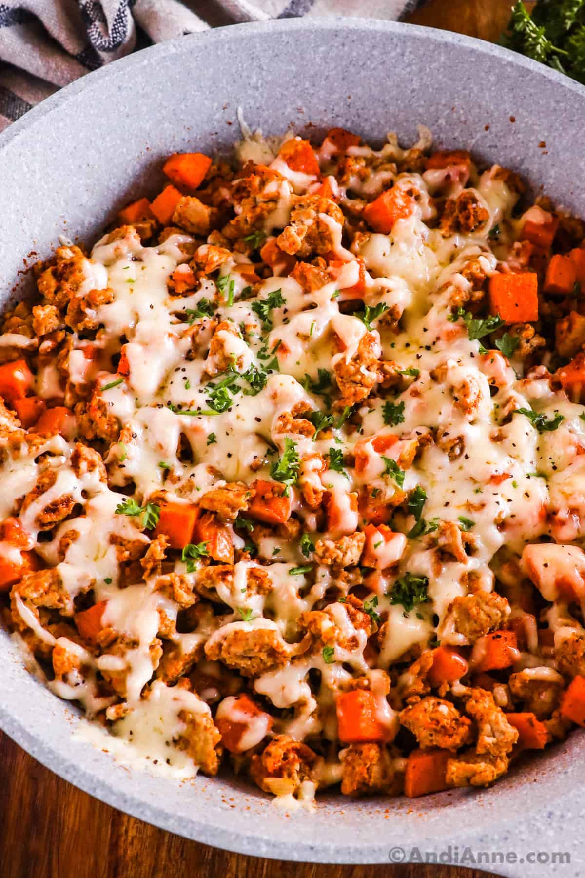 Ground turkey sweet potato recipe with melted cheese on top in a frying pan