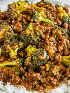 A plate of rice, ground beef and broccoli in a honey garlic sauce