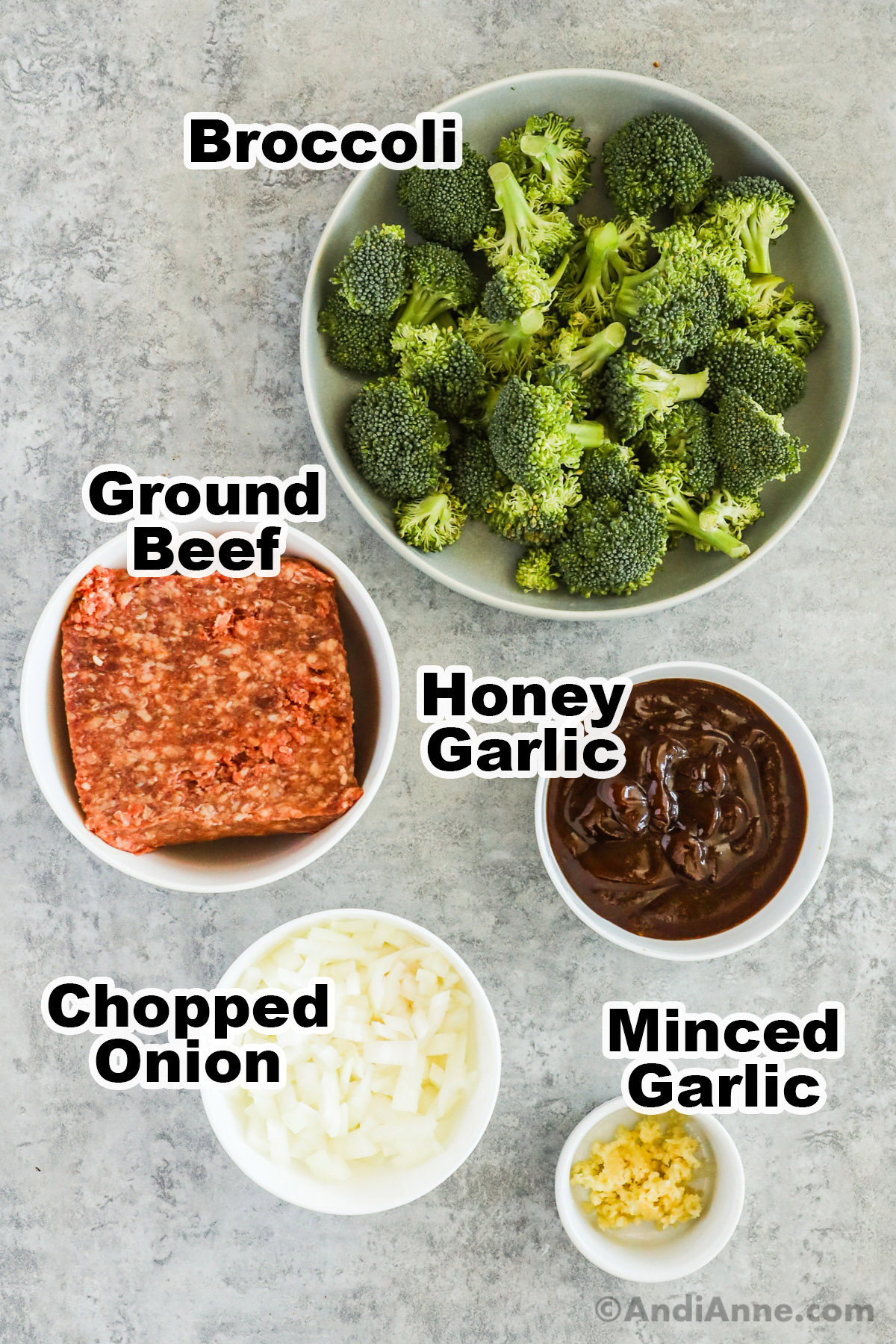 Recipe ingredients in bowls including broccoli florets, ground beef, honey garlic sauce, chopped onion, and minced garlic.