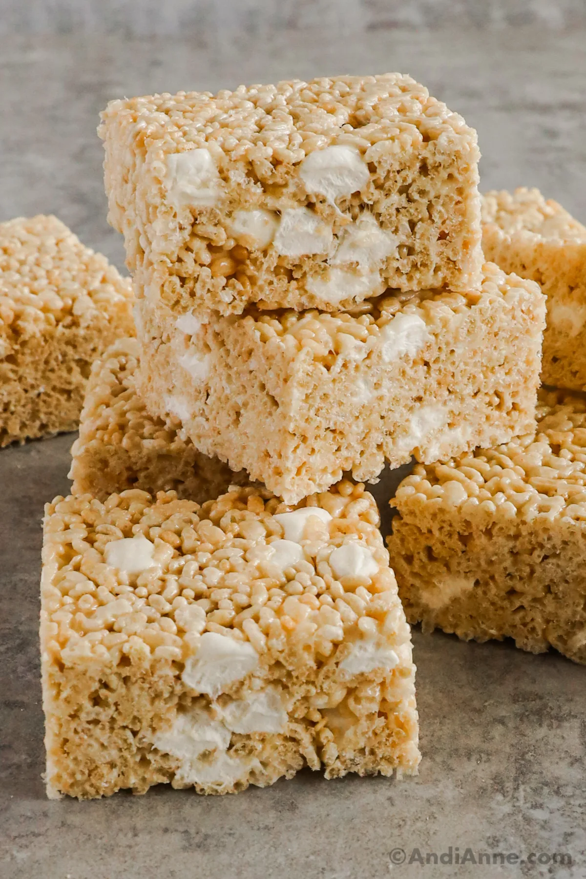 A stack of thick rice krispies treats with mini marshmallows inside.